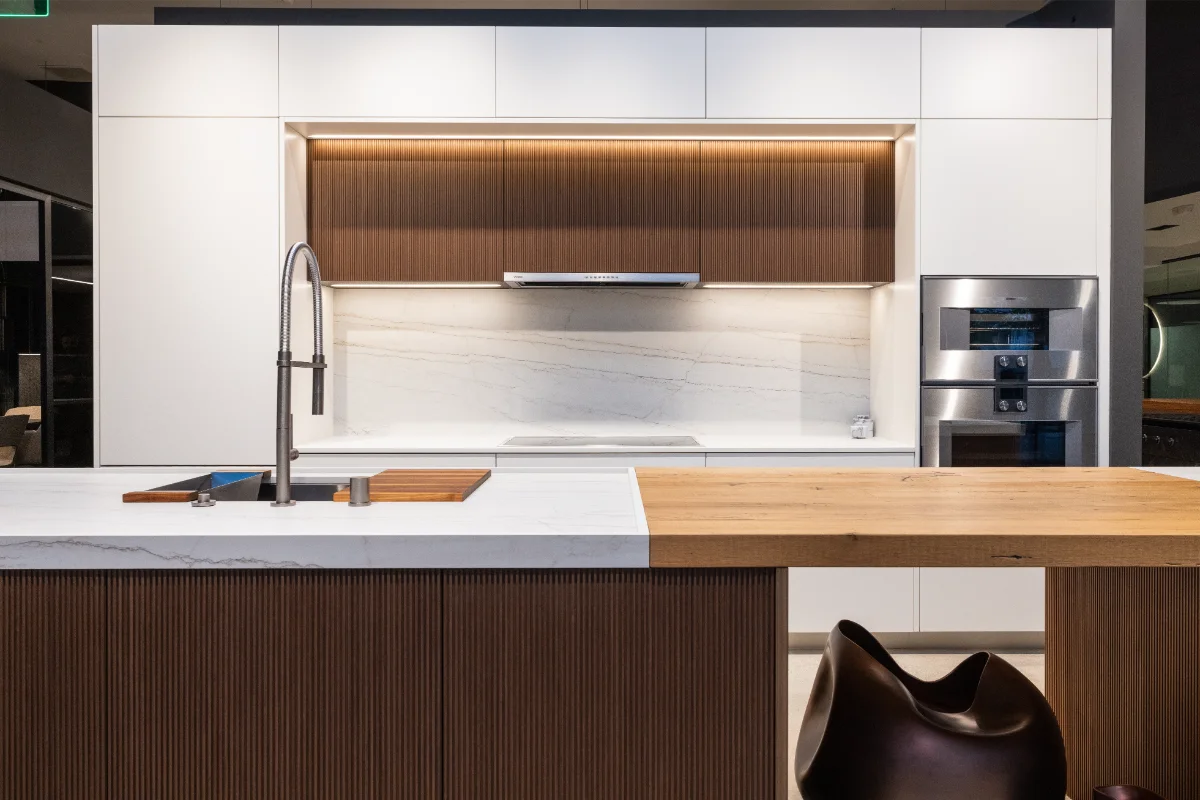 rastelli-LA-white-kitchen2 Italian frameless kitchen with white flat-panel cabinetry, marble backsplash, and fluted walnut island at Rastelli's Los Angeles kitchen design showroom